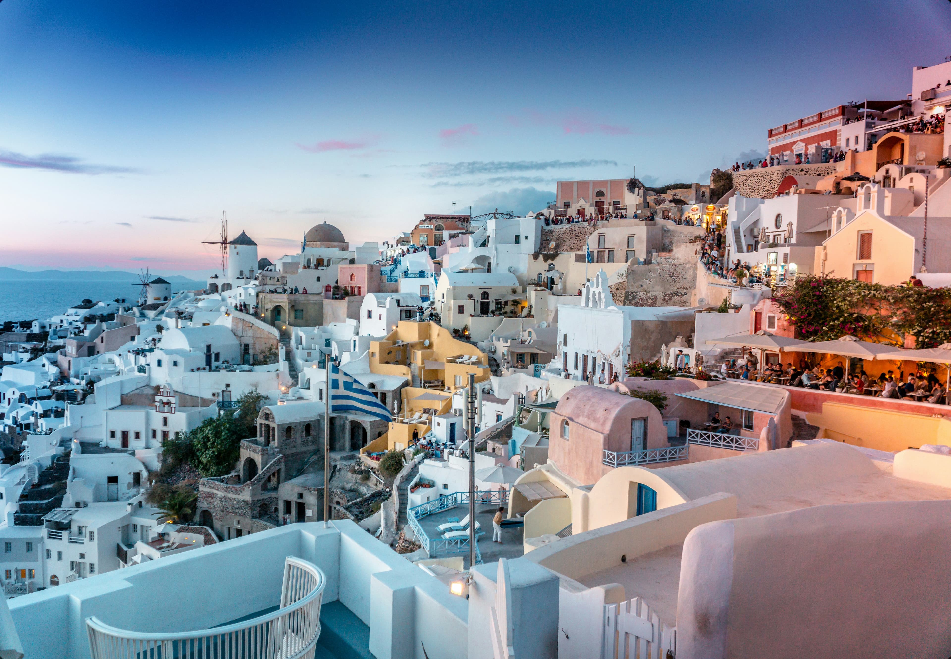Santorini at sunset - white buildings and the Aegean Sea